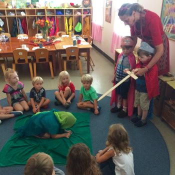 children and teacher playing king and knight