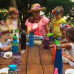 preschool children and teacher eating lunch outside