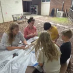 Teachers and Students around bench